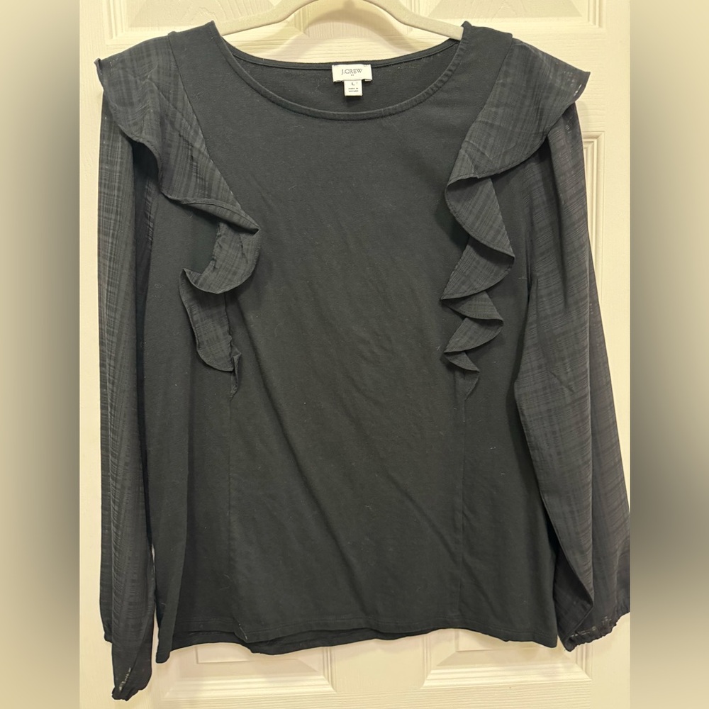 J Crew black top with ruffle sleeve.